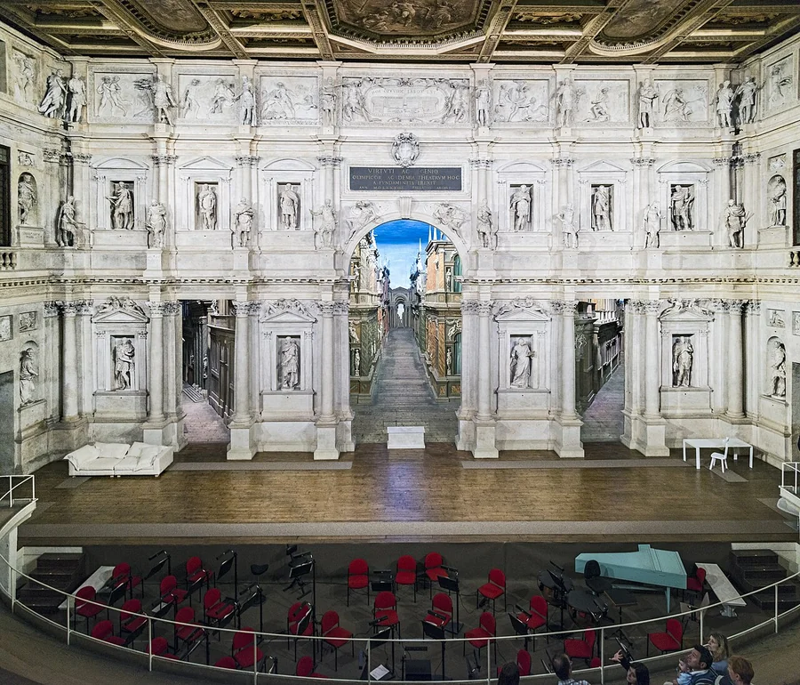 The stage front of Teatro Olimpico, with miniature perspective streets visible through its openings.