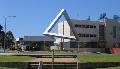 An outdoor metal sculpture appears to form a complete Penrose triangle from the chosen viewpoint.