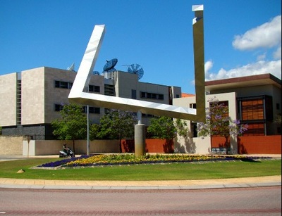 A second viewpoint of the outdoor triangle sculpture reveals its separated, angled beams.